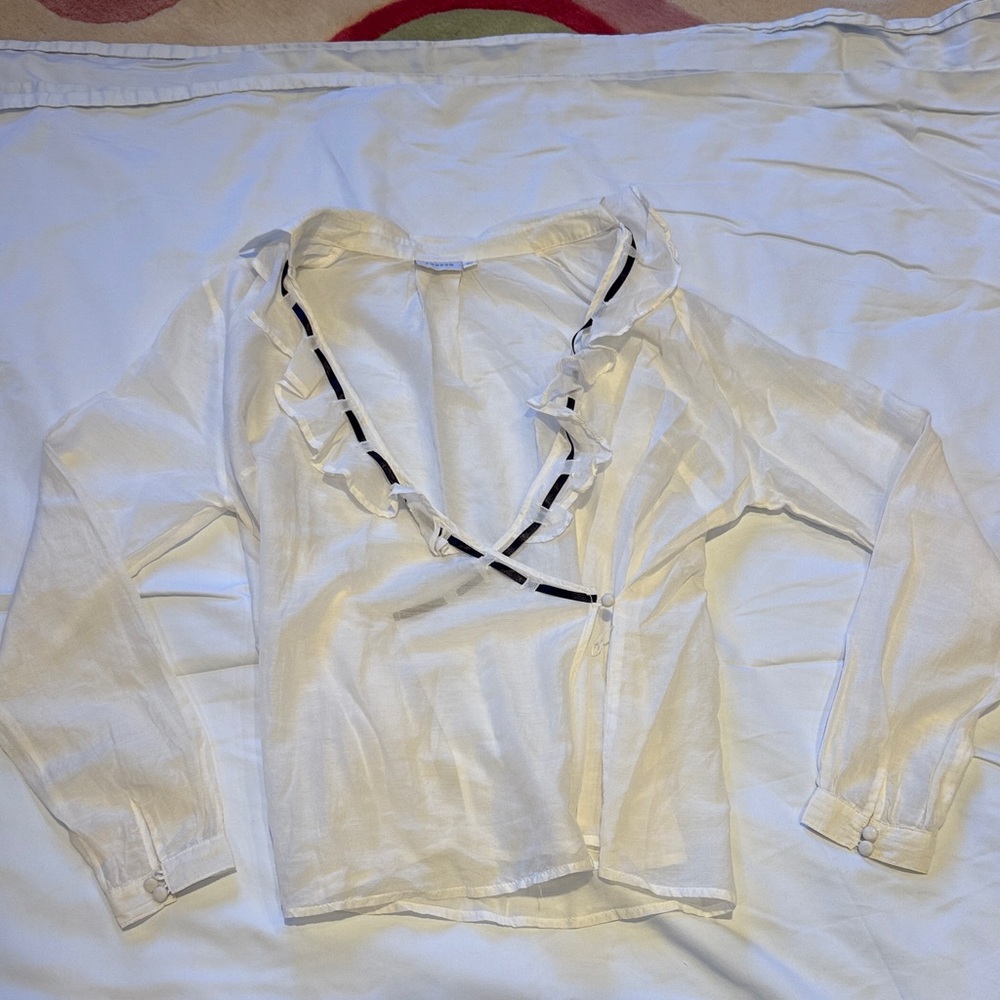 Chic White Ruffled Blouse with Black Trim